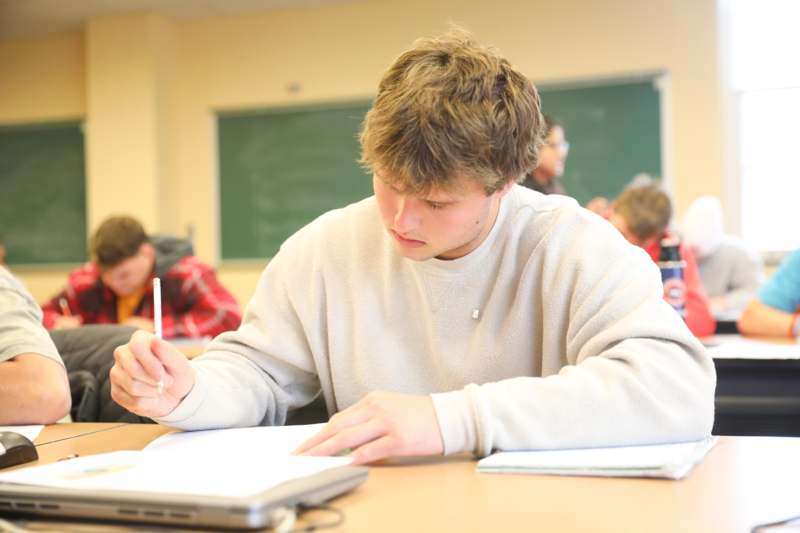 a man writing on a paper