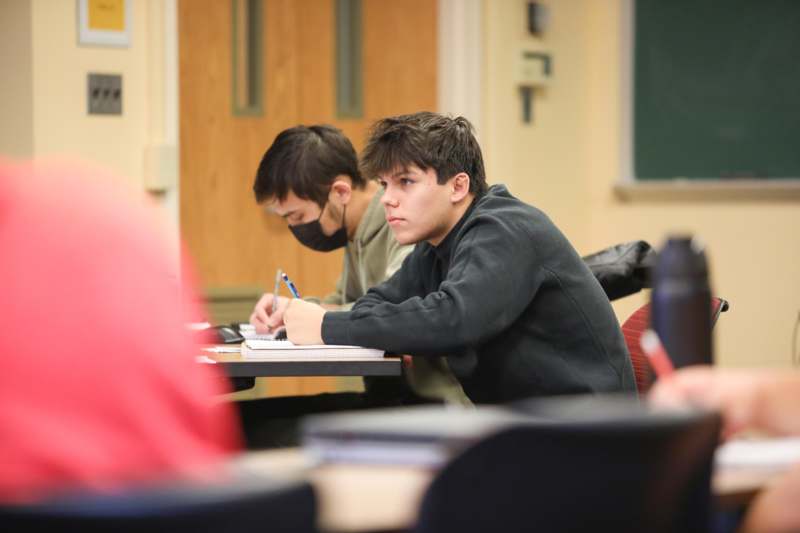 a group of people sitting at a desk