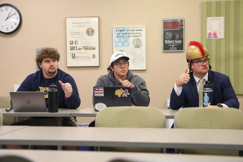 a group of men sitting at a table