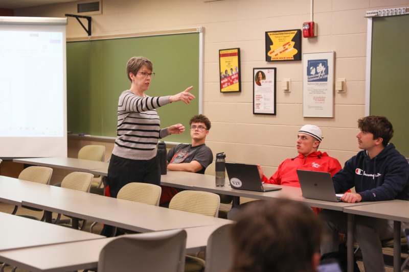 a woman standing in front of a group of people
