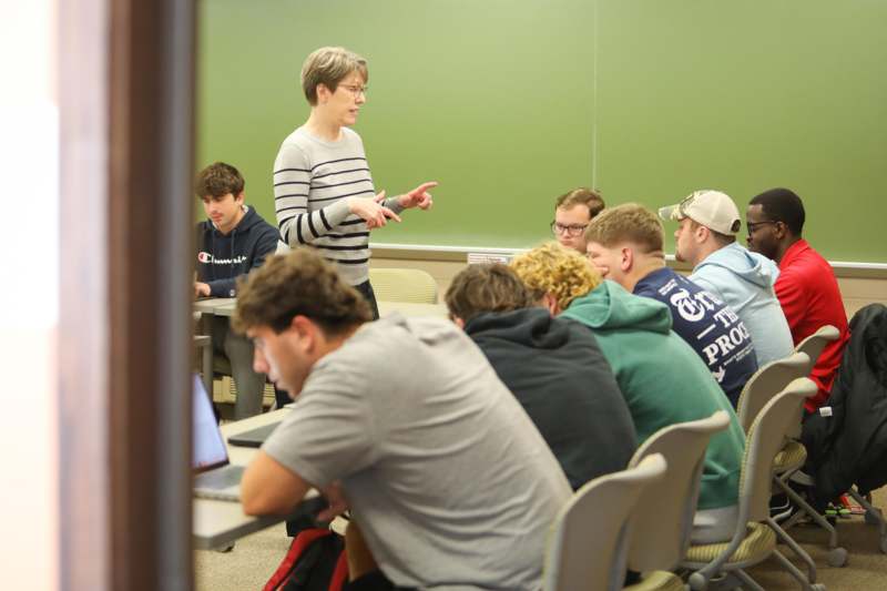 a woman standing in front of a group of people