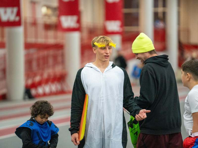 a man in a garment with a boy in a yellow hat