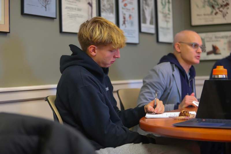 a group of men sitting at a table