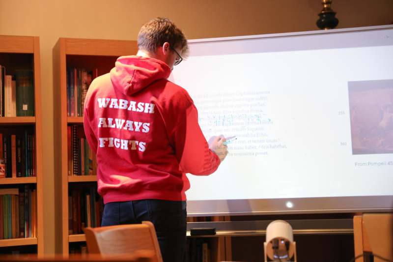 Classroom: LAT 301 with Professor Theodora Kopestonsky - a man writing on a white board