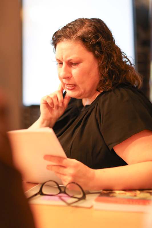 a woman holding a paper