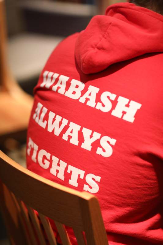 a person wearing a red shirt with white text on it