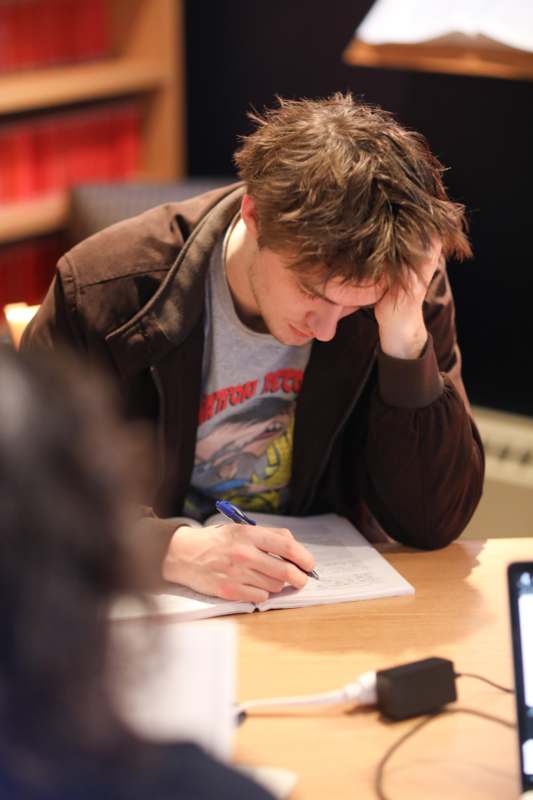 a man writing on a book