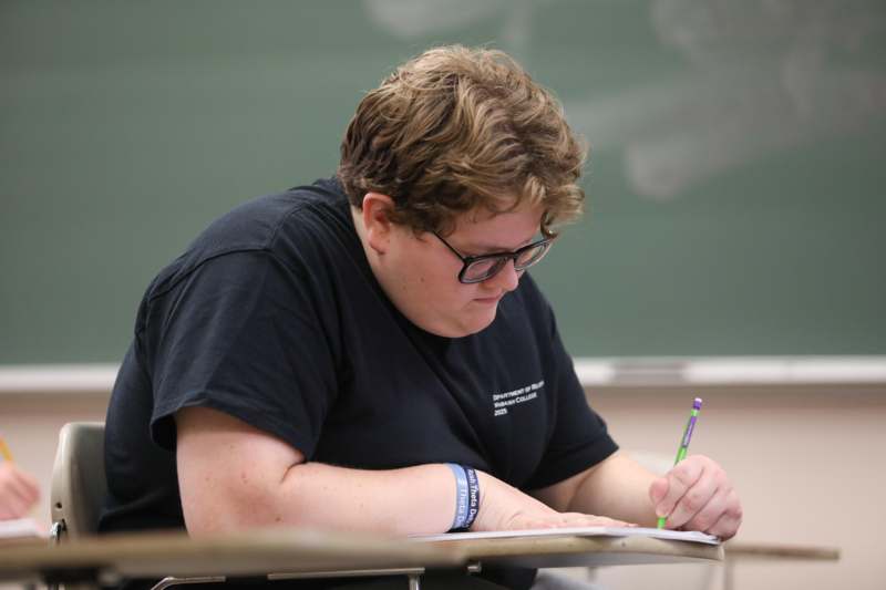 a person writing on a piece of paper