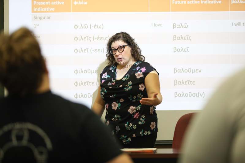 a woman standing in front of a screen