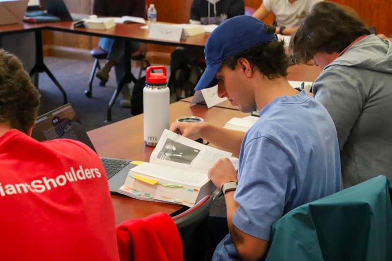 a man reading a book in a library