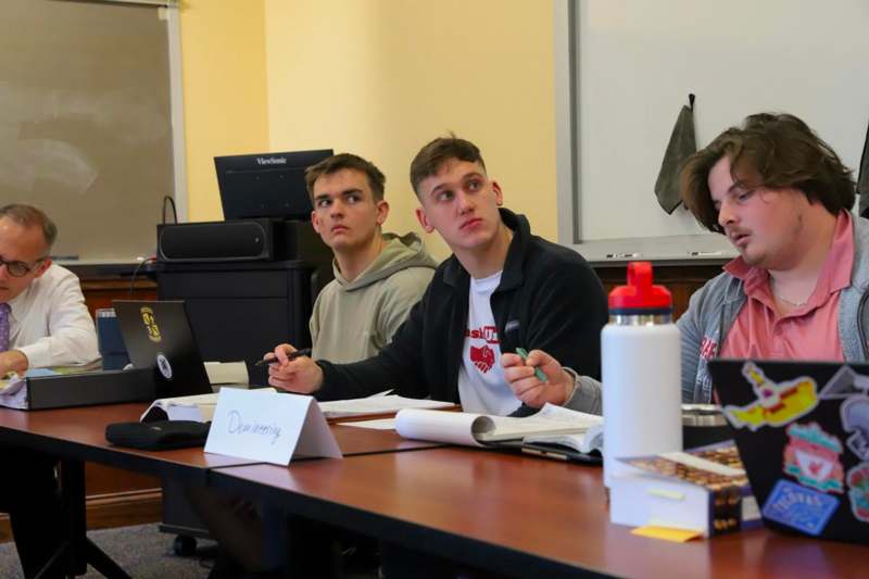 a group of men sitting at a table
