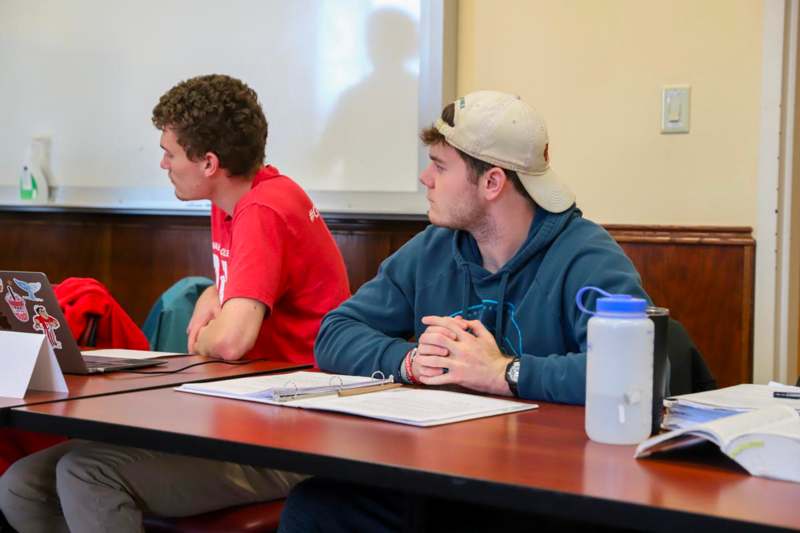 a group of men sitting at a table