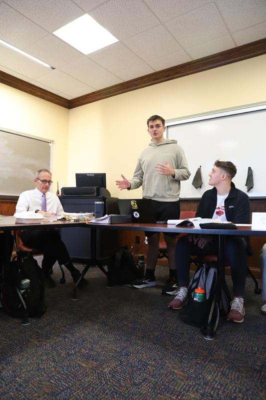 a man standing in front of a whiteboard