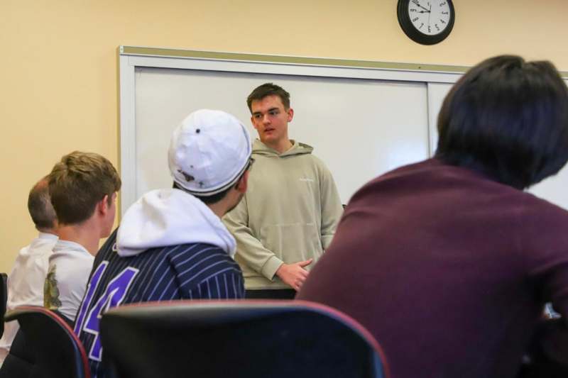 a man standing in front of a whiteboard