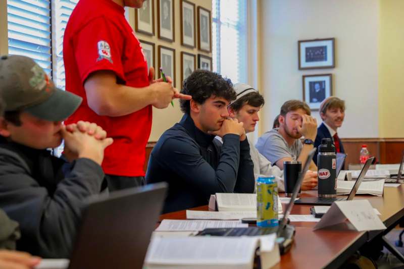 a group of people sitting at a table