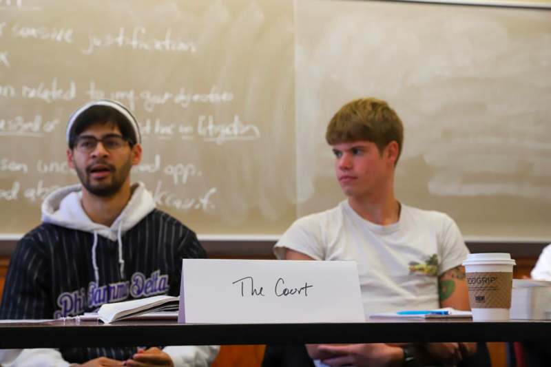a group of men sitting at a table