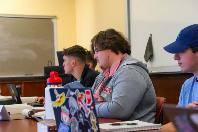 a group of people sitting at a desk