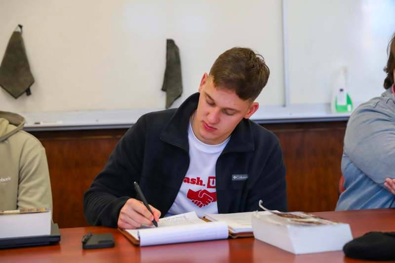a man writing on a book