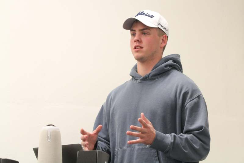 a man wearing a hat and grey sweatshirt