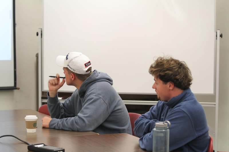 a group of men sitting at a table