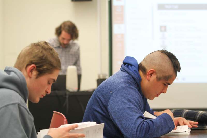 a group of men sitting at a table