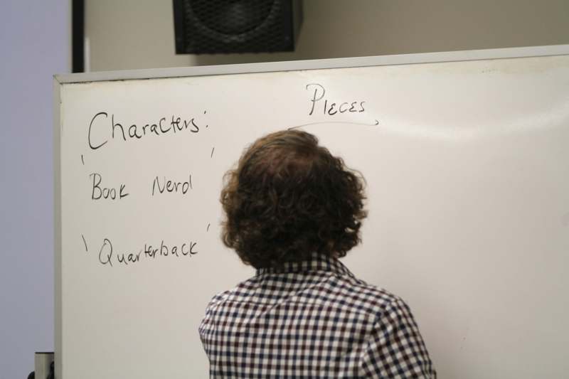 a person standing in front of a whiteboard
