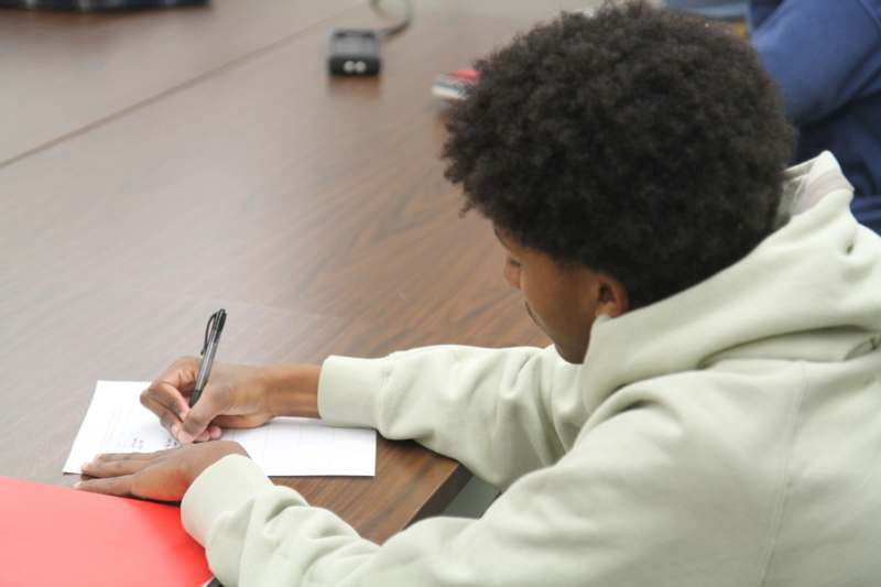 a person writing on a piece of paper