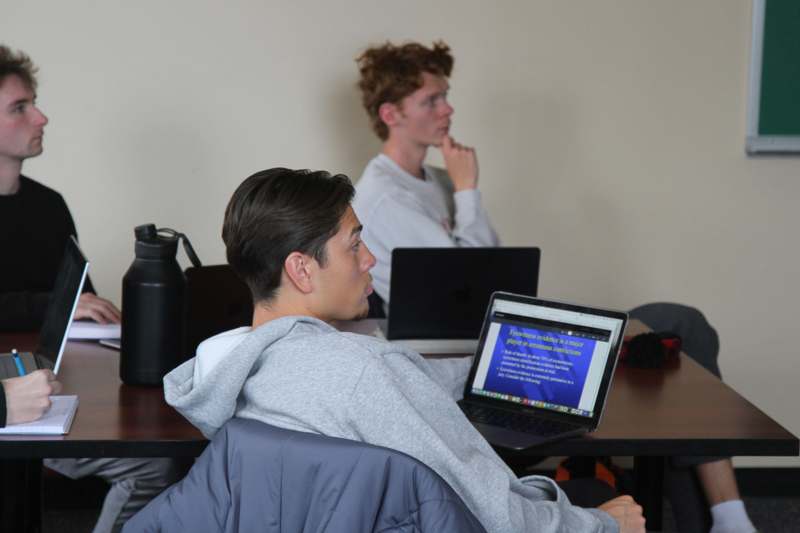 a man sitting at a table with a laptop