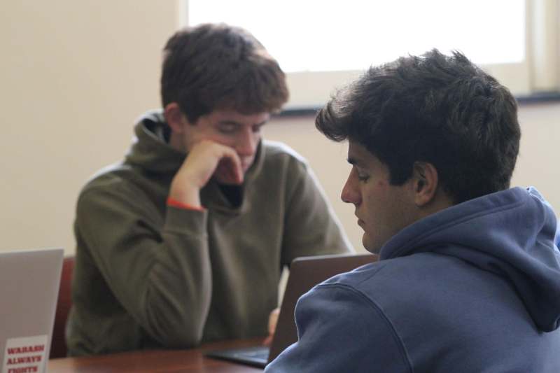 a group of men sitting at a table
