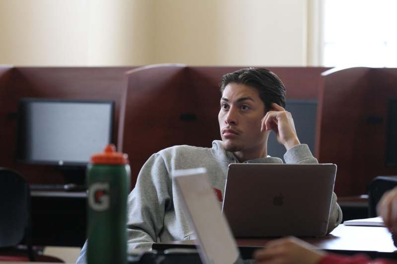 a man sitting at a table with a laptop