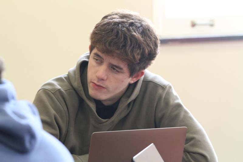 a man looking at a laptop