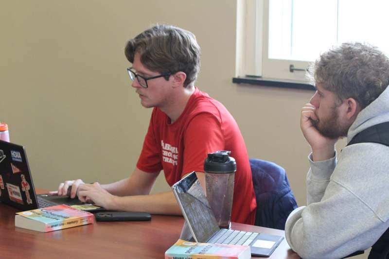 a group of men sitting at a table