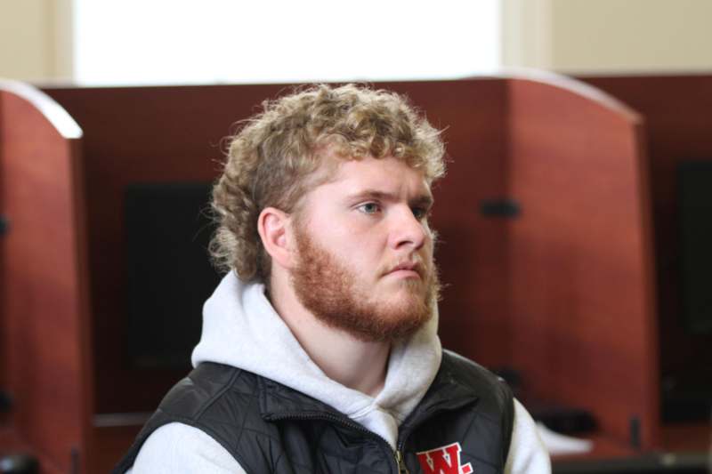 a man with a beard looking away