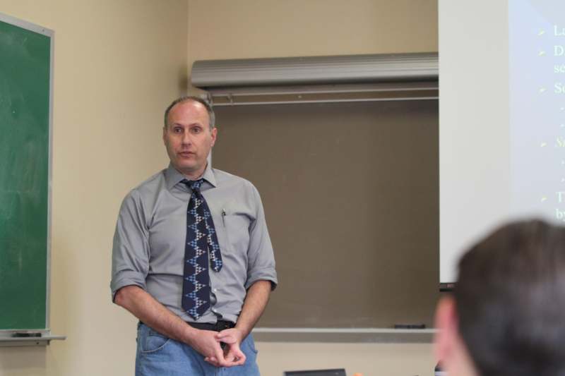 a man standing in front of a whiteboard