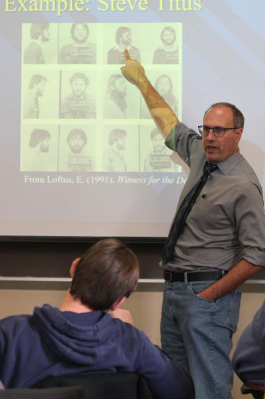 a man pointing at a projector screen