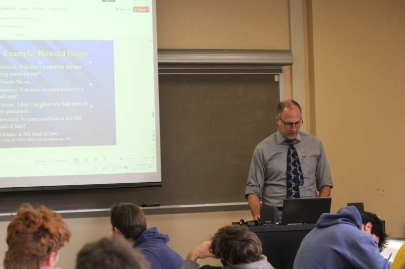 a man standing in front of a screen