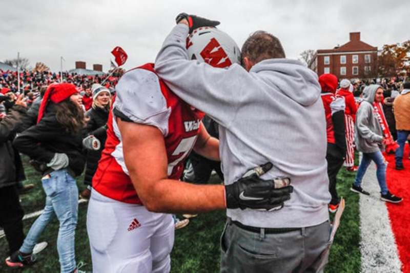 a football player hugging another football player