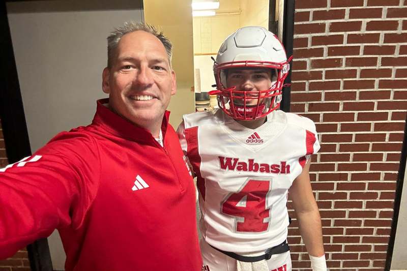 a man taking a selfie with a football player