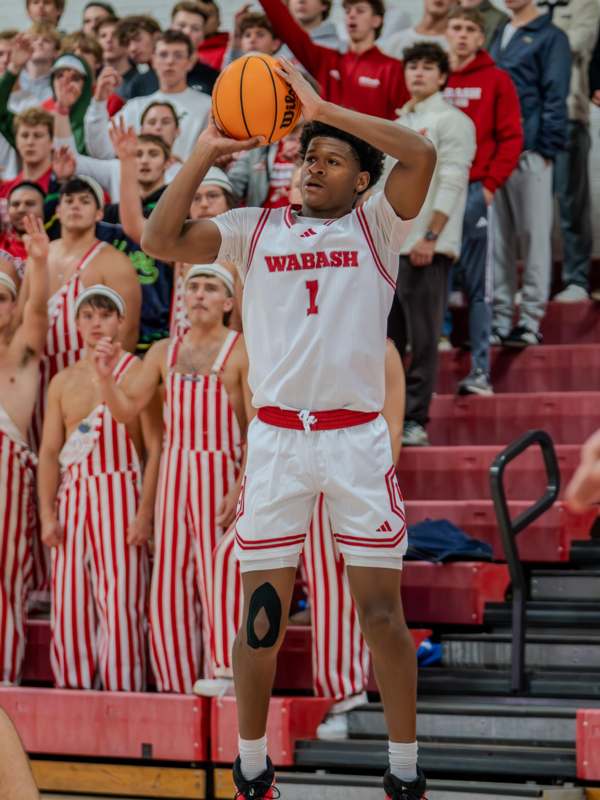 a man in a basketball uniform holding a basketball