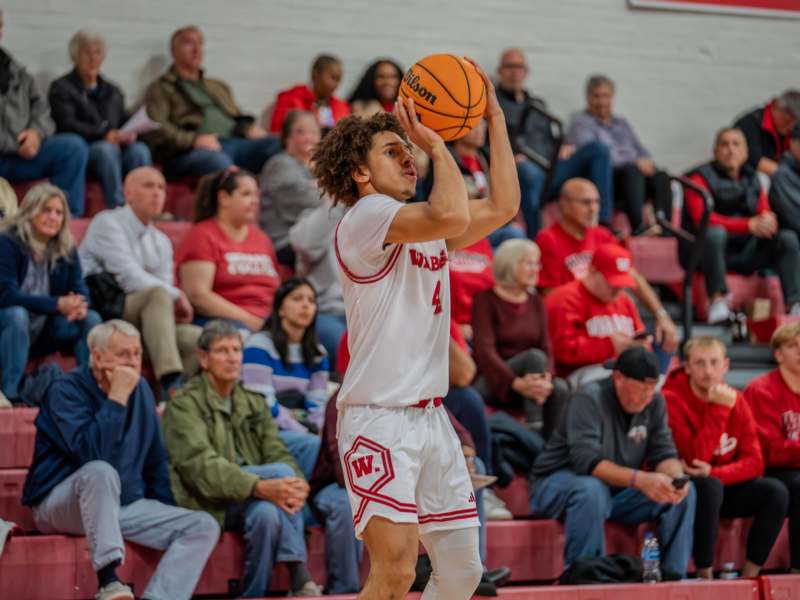 a man in a basketball uniform with a ball in his hand
