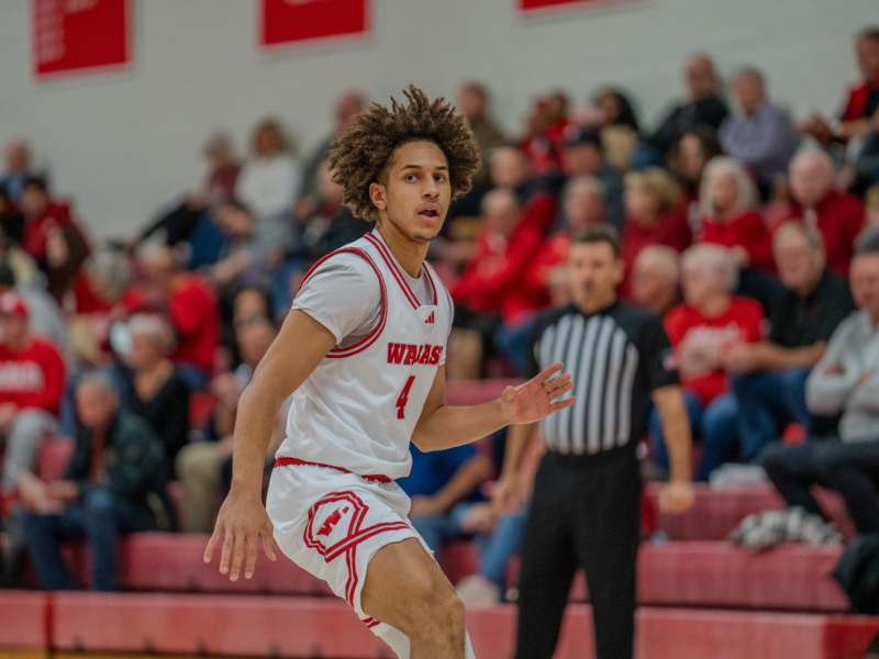 a basketball player in a white uniform