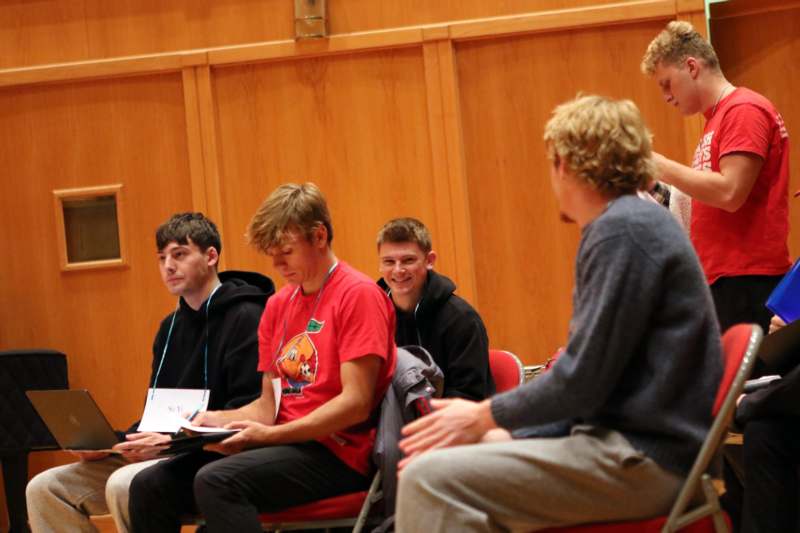 a group of men sitting in chairs