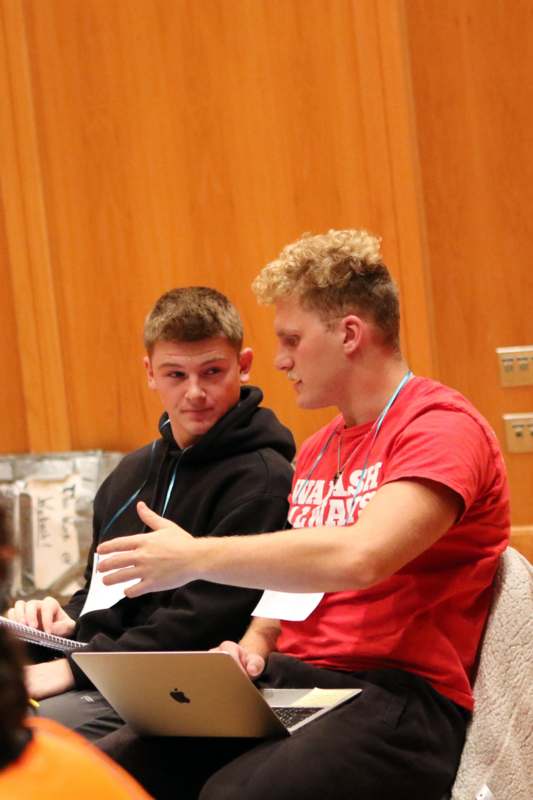 a couple of men sitting in a chair