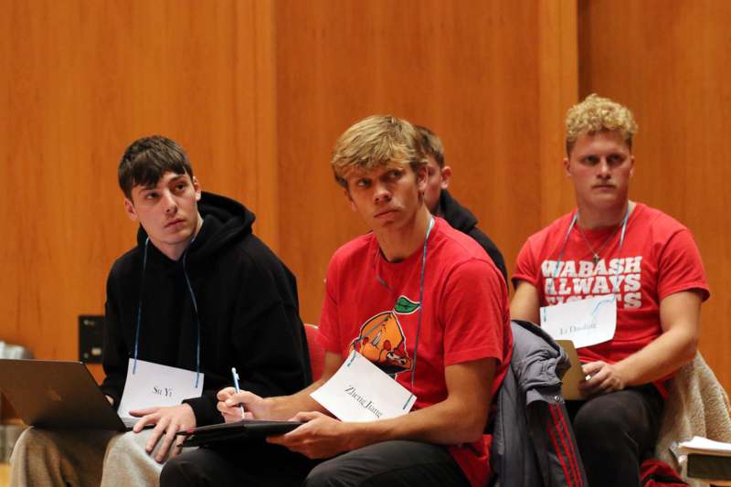 a group of men sitting in chairs
