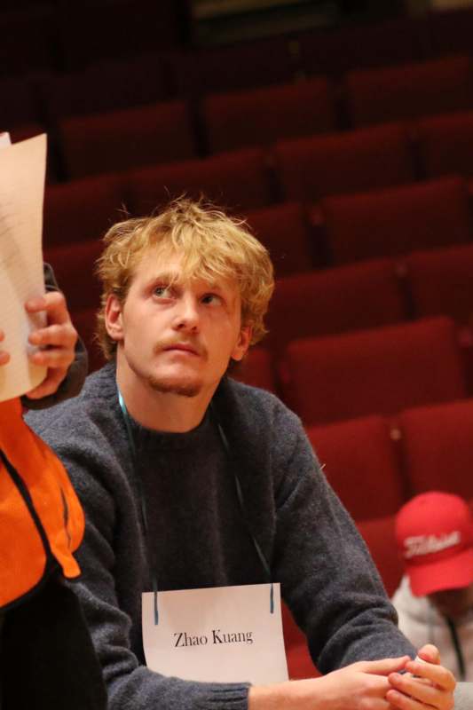 a man holding papers in front of a person