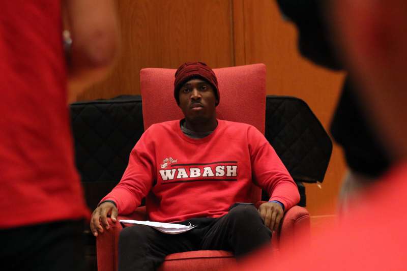 a man sitting in a red chair