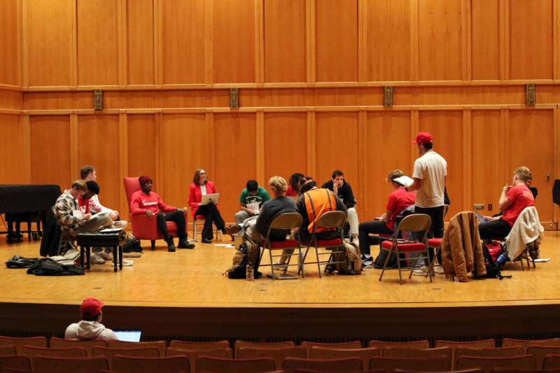 a group of people sitting in chairs in a room