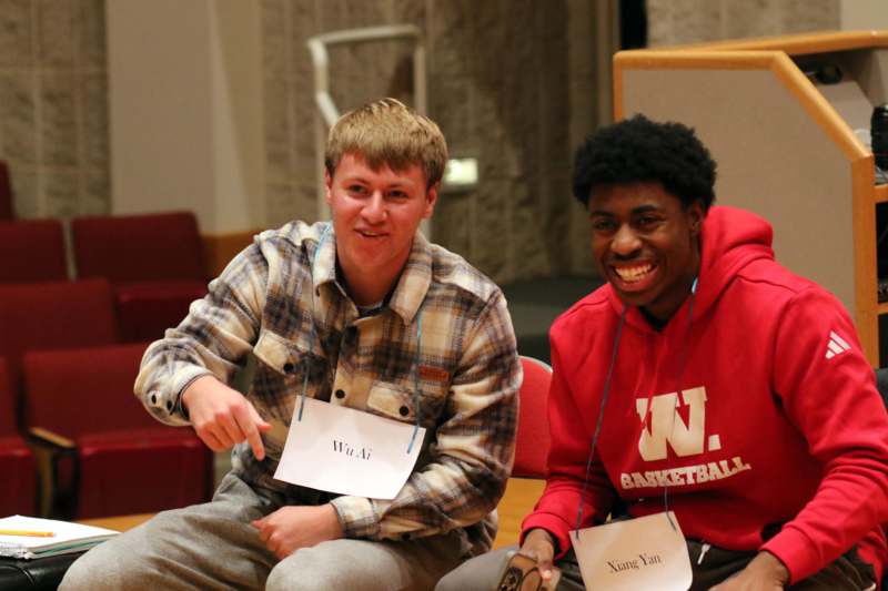 a couple of men sitting on the floor