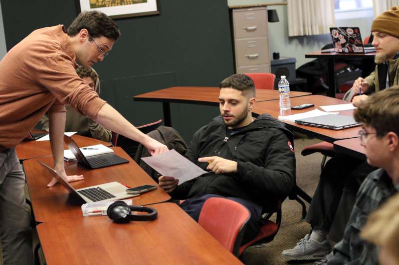 a man pointing at a piece of paper