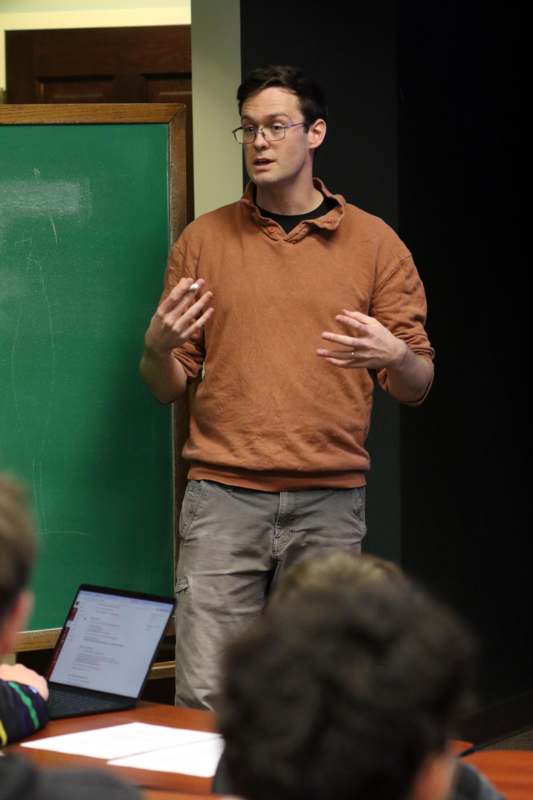 a man standing in front of a chalkboard